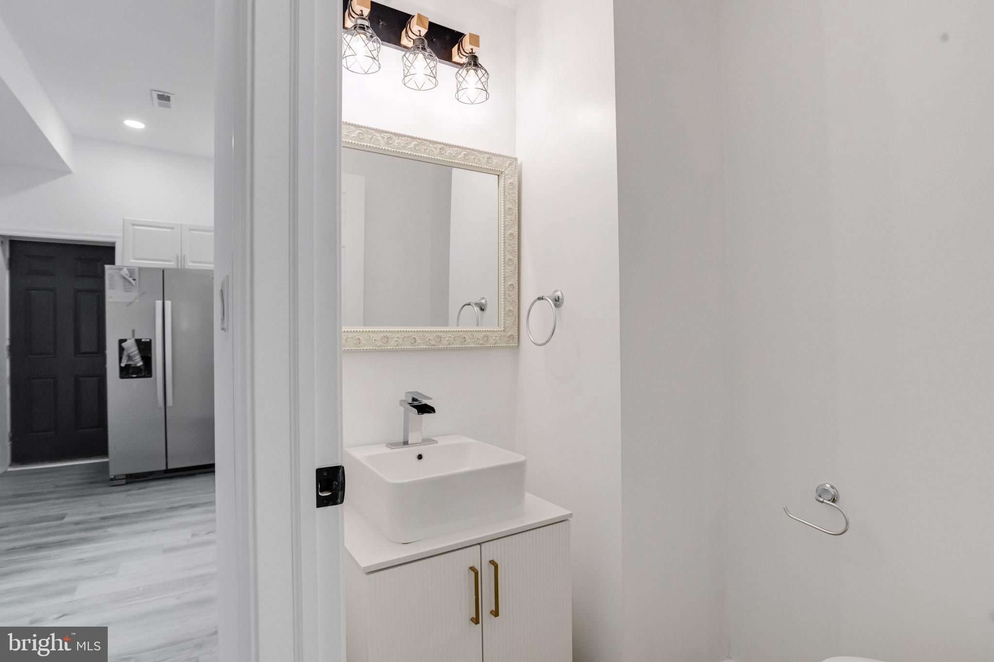 3015 Windsor Avenue Baltimore, MD 21216 - Photo 32 of 84 a bathroom with a sink and a mirror