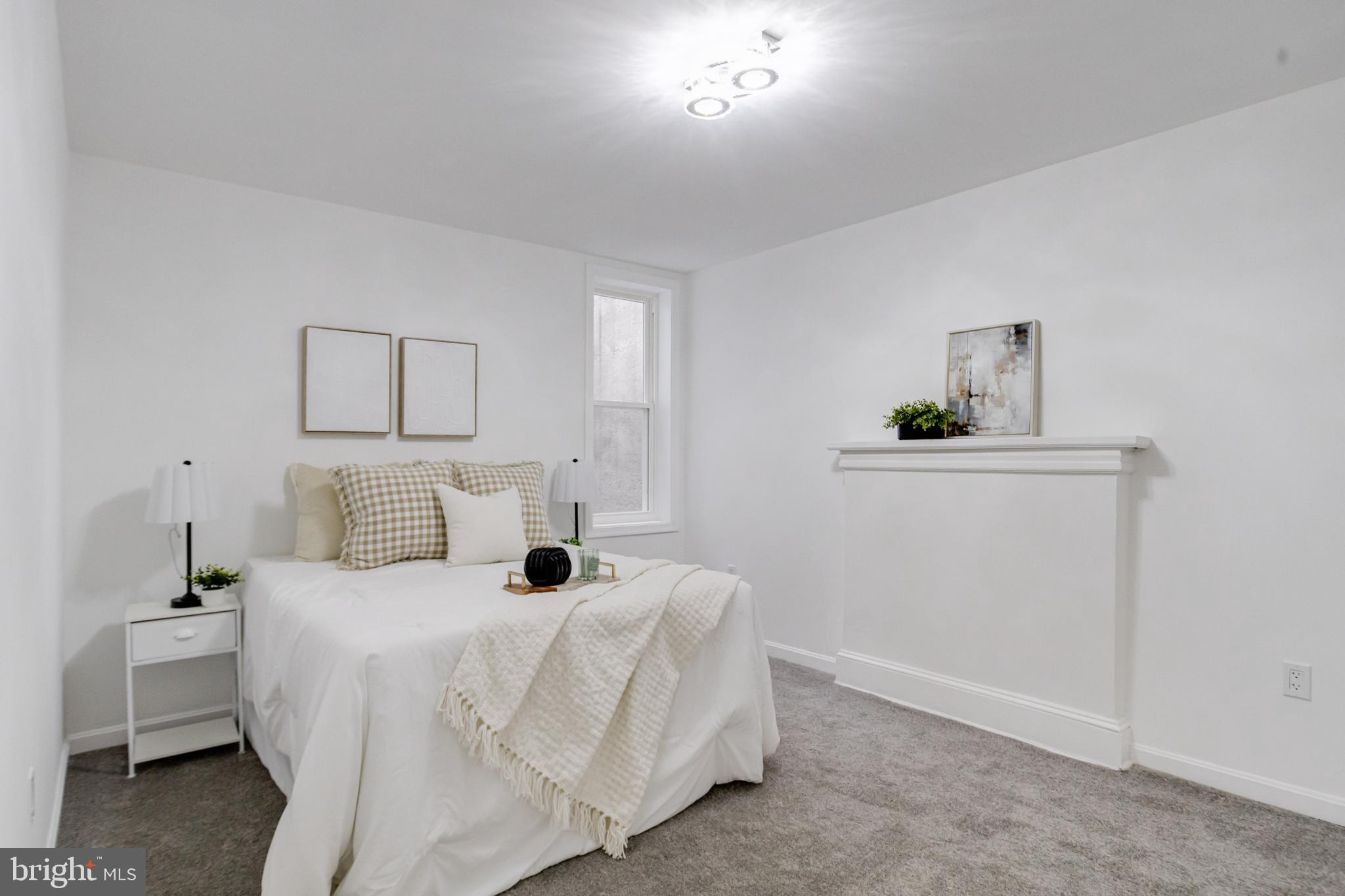 3015 Windsor Avenue Baltimore, MD 21216 - Photo 55 of 84 a bed room with a bed and a lamp