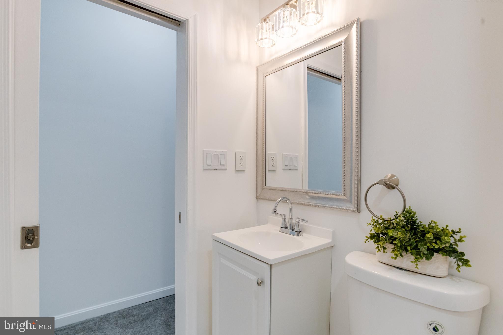 3015 Windsor Avenue Baltimore, MD 21216 - Photo 66 of 84 a bathroom with a toilet sink and mirror