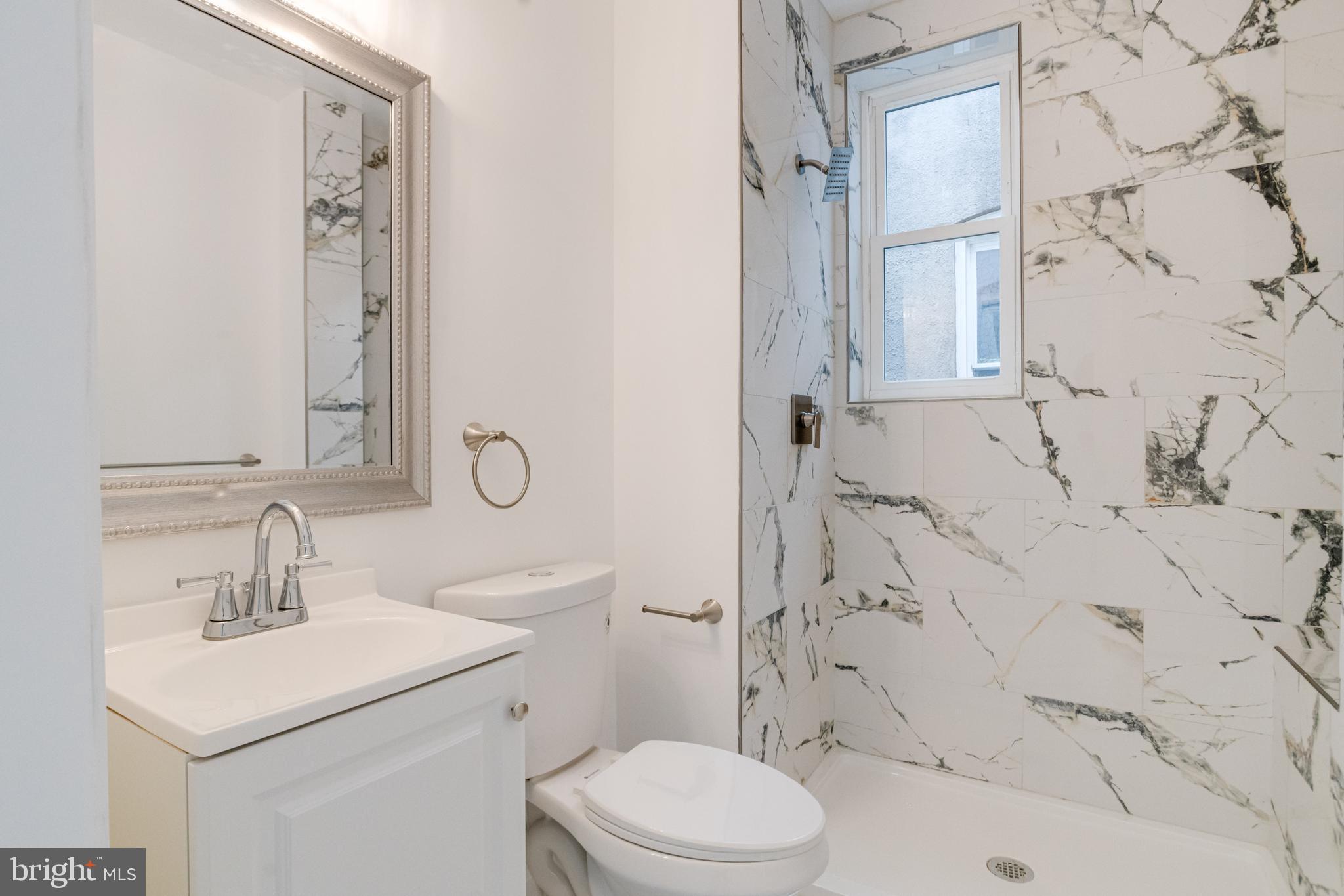 3015 Windsor Avenue Baltimore, MD 21216 - Photo 69 of 84 a bathroom with a sink toilet vanity and shower