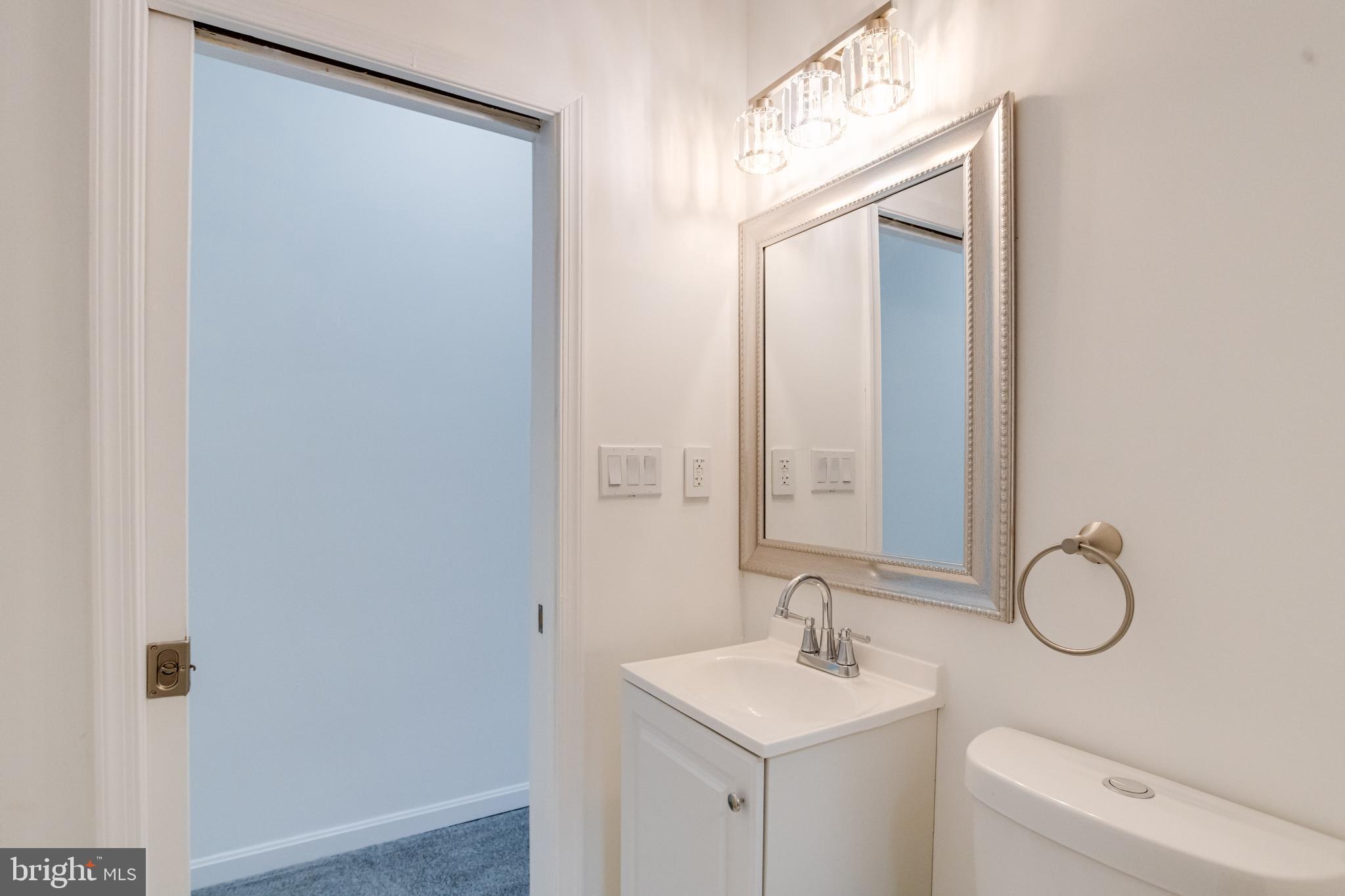 3015 Windsor Avenue Baltimore, MD 21216 - Photo 72 of 84 a bathroom with a sink and a mirror
