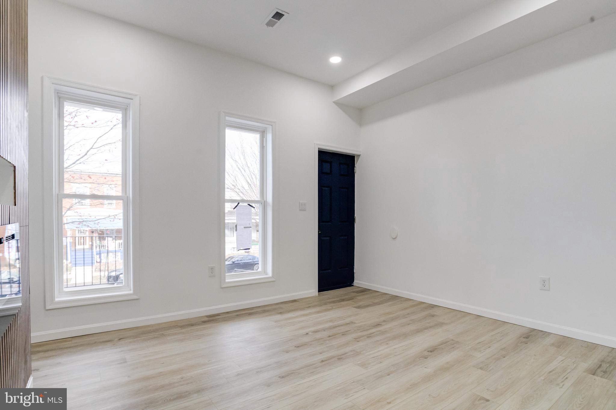 3015 Windsor Avenue Baltimore, MD 21216 - Photo 9 of 84 an empty room with wooden floor and windows