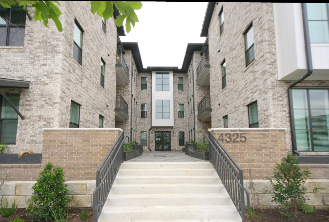 a view of a brick house with large windows