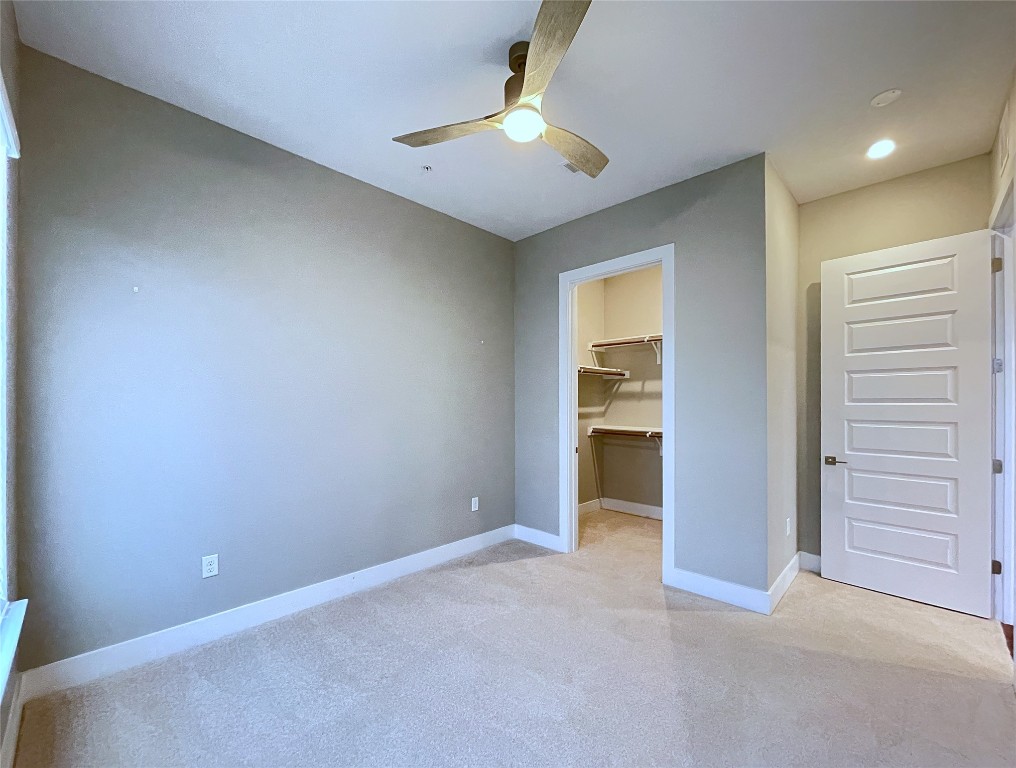 4325 Jackson Avenue, Unit 2301 Austin, TX 78731 - Photo 11 of 31 an empty room with closet and a ceiling fan