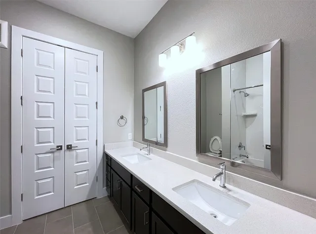 a bathroom with a double vanity sink mirror and double