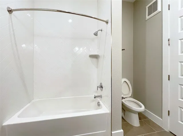 a bathroom with a shower and a toilet