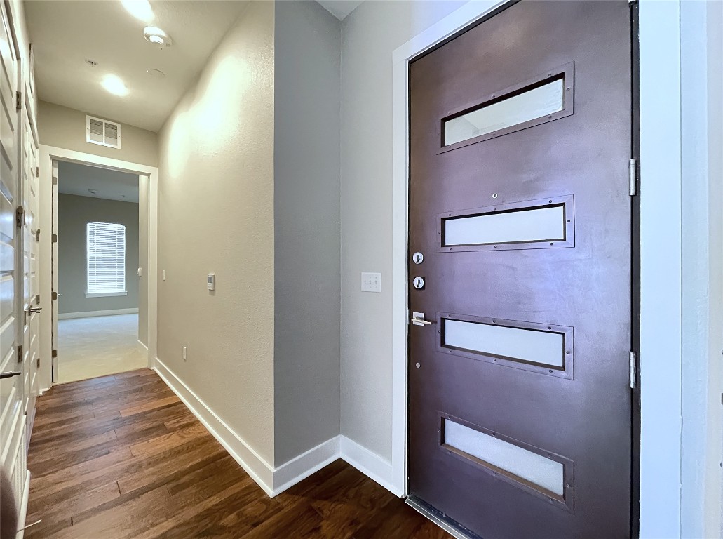 4325 Jackson Avenue, Unit 2301 Austin, TX 78731 - Photo 3 of 31 a view of a hallway with wooden floor