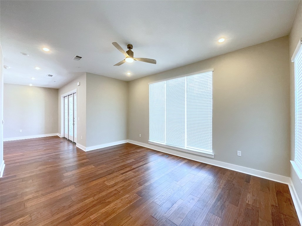 4325 Jackson Avenue, Unit 2301 Austin, TX 78731 - Photo 9 of 31 a view of an empty room with wooden floor and a ceiling fan