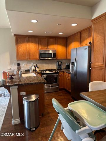 a kitchen with stainless steel appliances granite countertop a sink refrigerator and stove