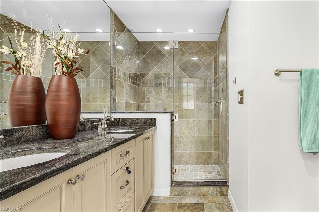 670 27th Street Northwest Naples, FL 34120 - Photo 12 of 39 a bathroom with a granite countertop sink a mirror and shower