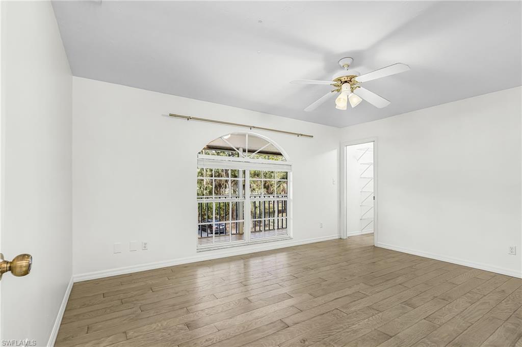 670 27th Street Northwest Naples, FL 34120 - Photo 14 of 39 wooden floor in an empty room with a window