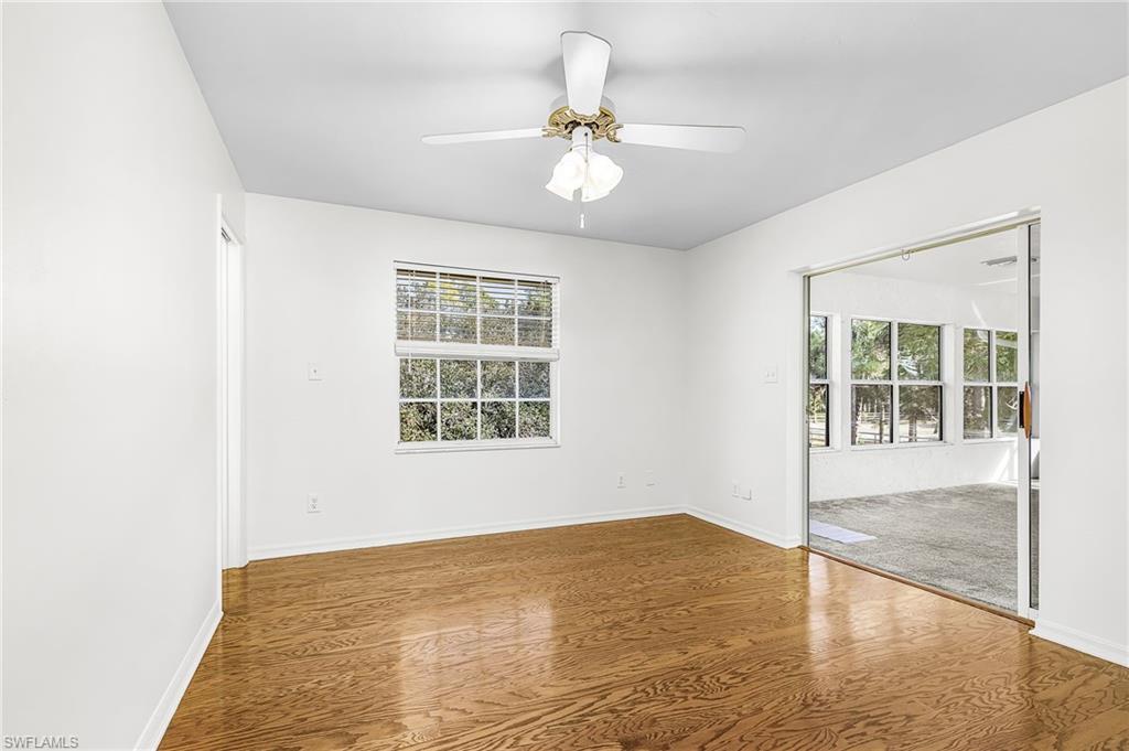 670 27th Street Northwest Naples, FL 34120 - Photo 16 of 39 an empty room with wooden floor and windows
