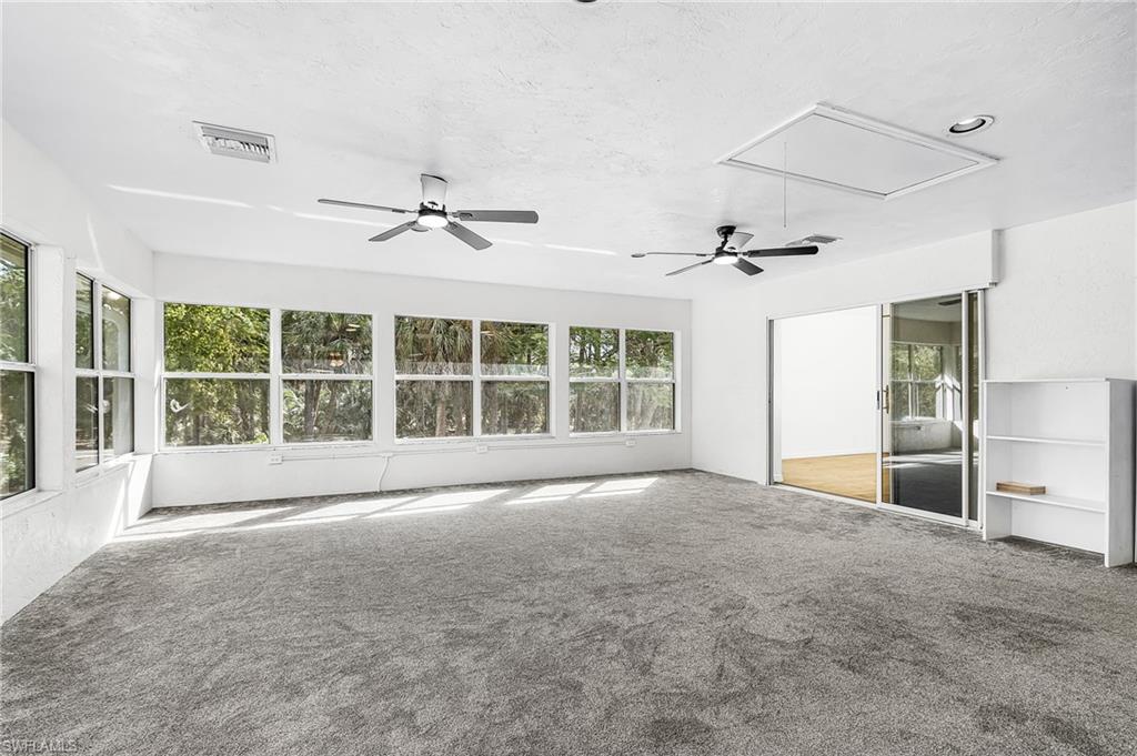670 27th Street Northwest Naples, FL 34120 - Photo 17 of 39 a view of an empty room with a window and a ceiling fan