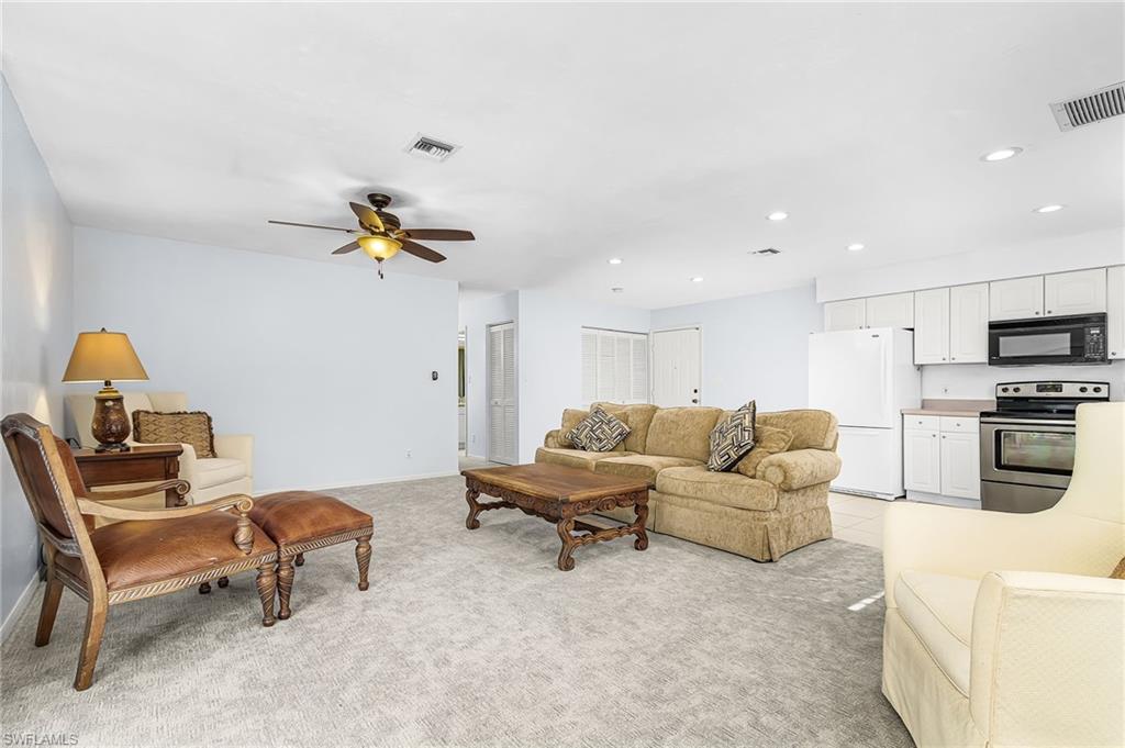 670 27th Street Northwest Naples, FL 34120 - Photo 18 of 39 a living room with furniture and kitchen view