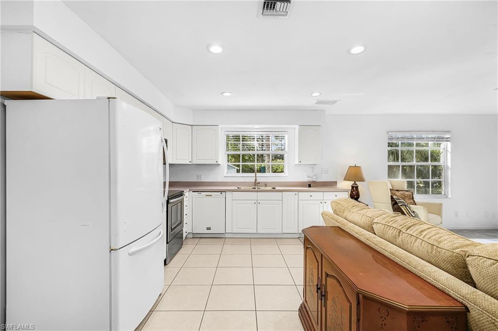 670 27th Street Northwest Naples, FL 34120 - Photo 20 of 39 a kitchen with a refrigerator and white cabinets