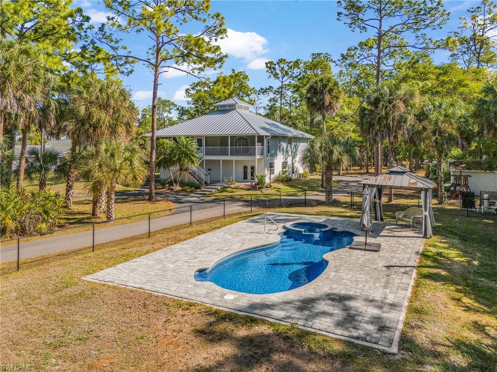 670 27th Street Northwest Naples, FL 34120 - Photo 2 of 39 a view of a swimming pool with sitting area