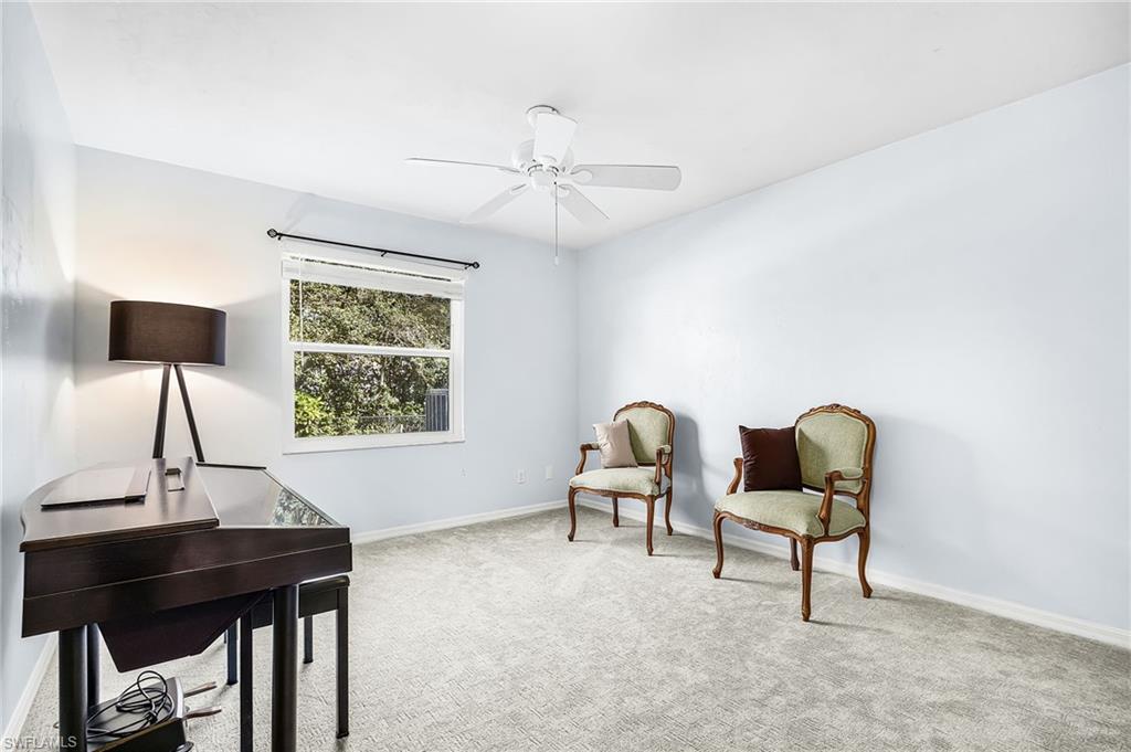 670 27th Street Northwest Naples, FL 34120 - Photo 23 of 39 a living room with furniture and a window