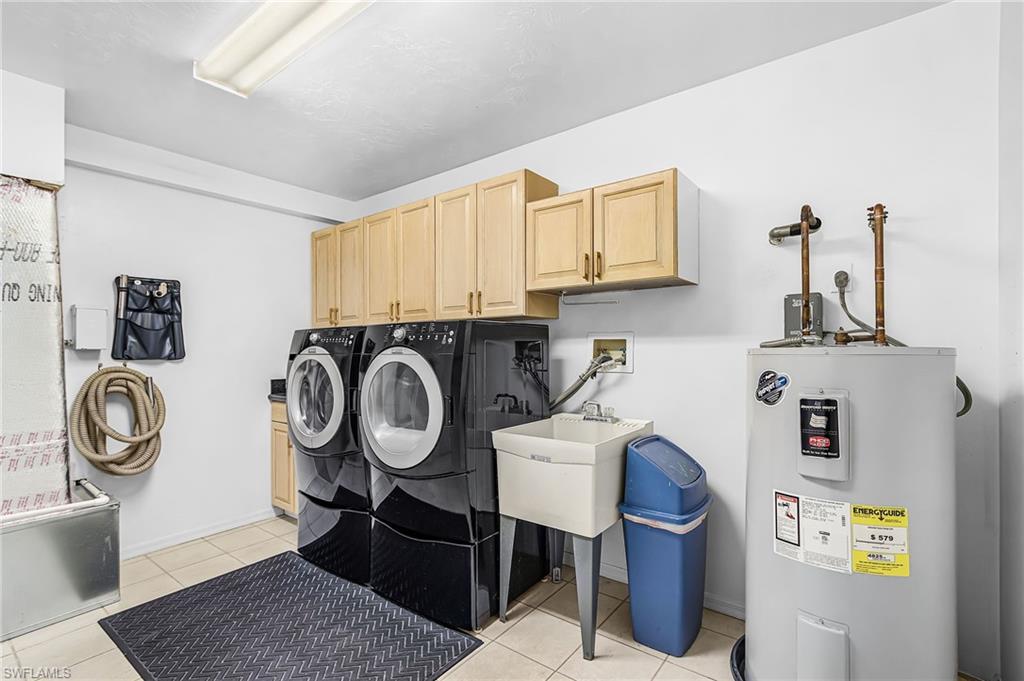 670 27th Street Northwest Naples, FL 34120 - Photo 26 of 39 a view of storage and utility room with washer and dryer