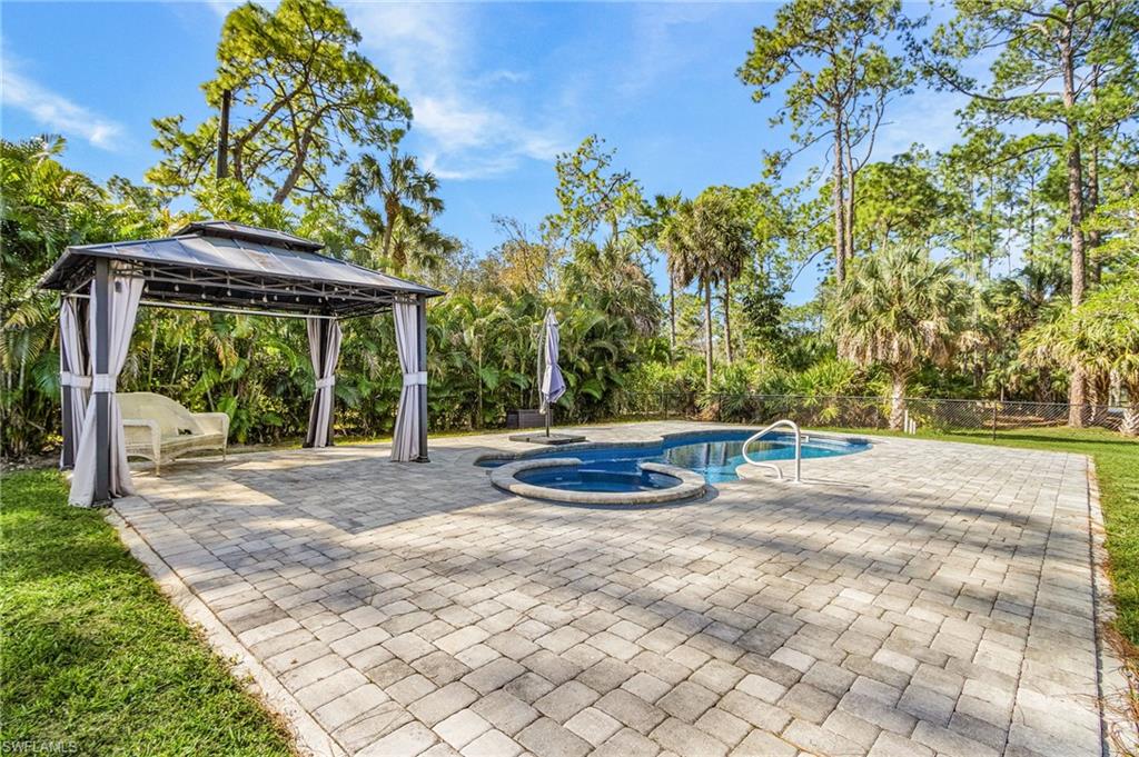 670 27th Street Northwest Naples, FL 34120 - Photo 30 of 39 a view of a house with backyard and a tree