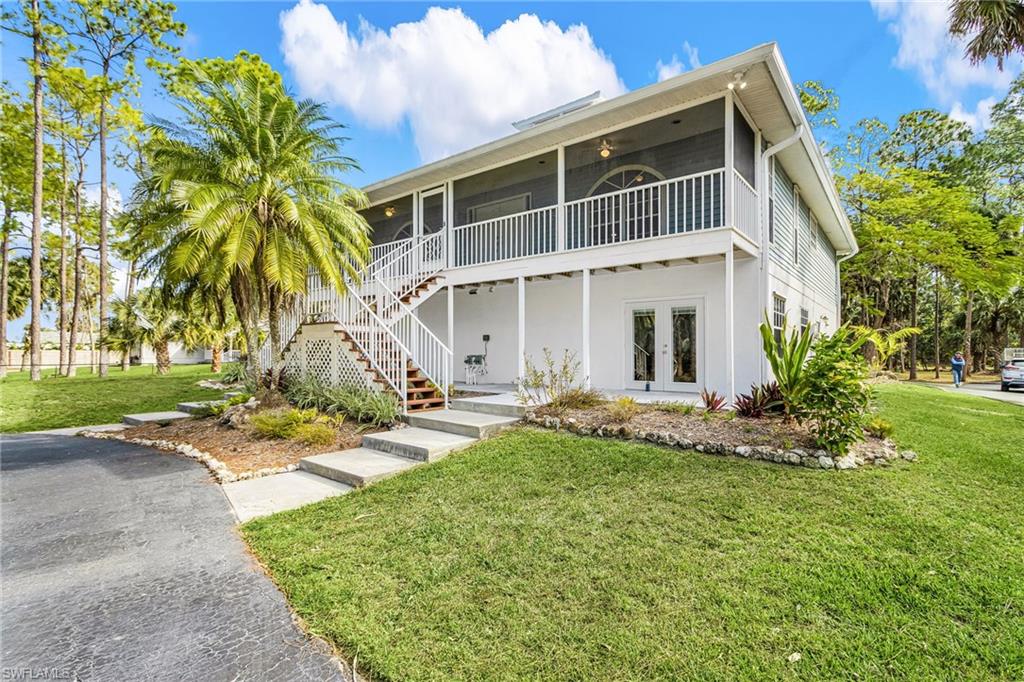 670 27th Street Northwest Naples, FL 34120 - Photo 3 of 39 a view of house with yard and sitting area