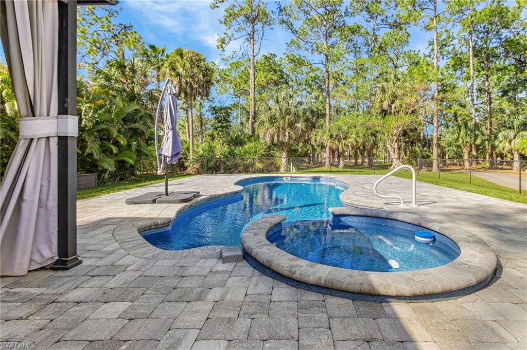 670 27th Street Northwest Naples, FL 34120 - Photo 32 of 39 a view of a swimming pool with an outdoor space