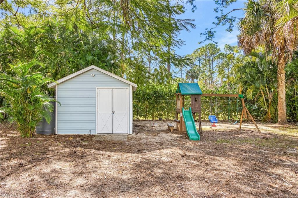 670 27th Street Northwest Naples, FL 34120 - Photo 33 of 39 a front view of a house with a yard