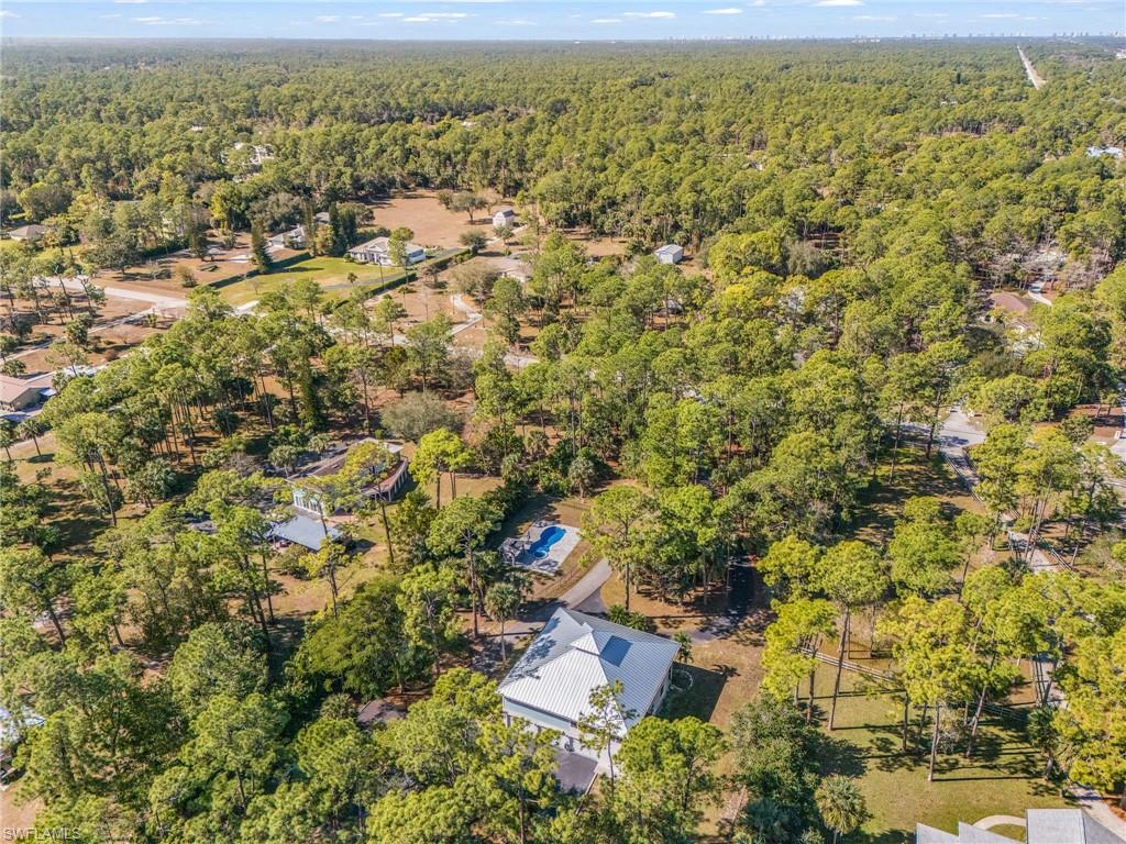 670 27th Street Northwest Naples, FL 34120 - Photo 38 of 39 an aerial view of residential houses with outdoor space and trees