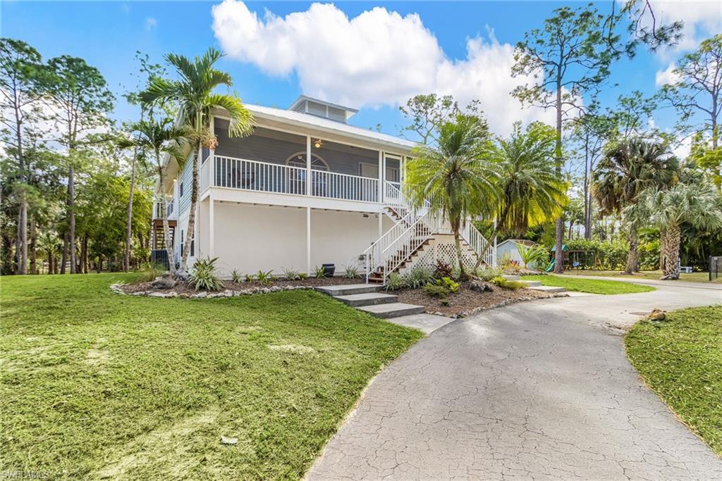 670 27th Street Northwest Naples, FL 34120 - Photo 4 of 39 a view of a house with a yard
