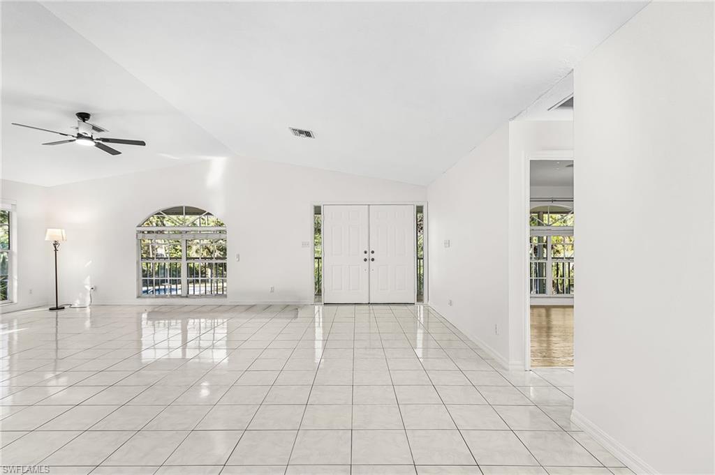 670 27th Street Northwest Naples, FL 34120 - Photo 5 of 39 an empty room with windows and fan