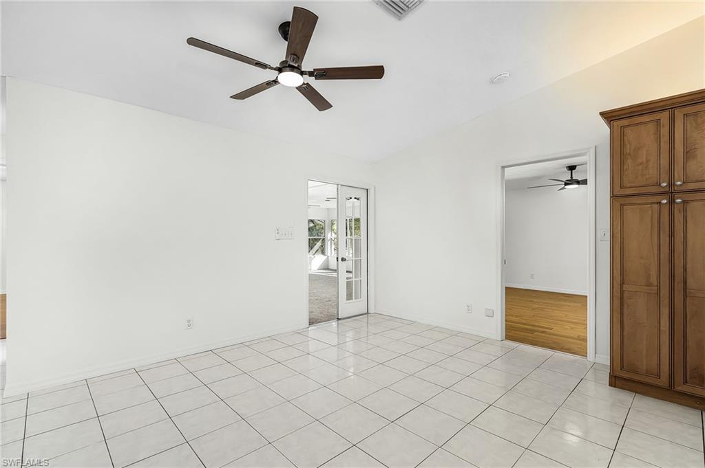 670 27th Street Northwest Naples, FL 34120 - Photo 8 of 39 a view of a livingroom with wooden floor and a ceiling fan