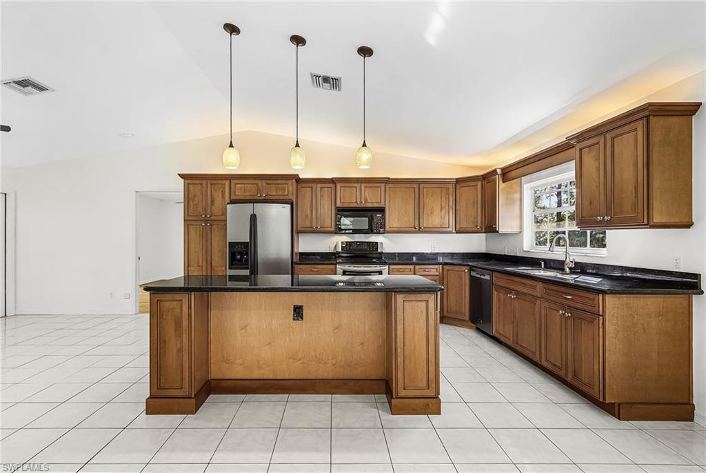 670 27th Street Northwest Naples, FL 34120 - Photo 9 of 39 a kitchen with stainless steel appliances granite countertop a stove and a sink