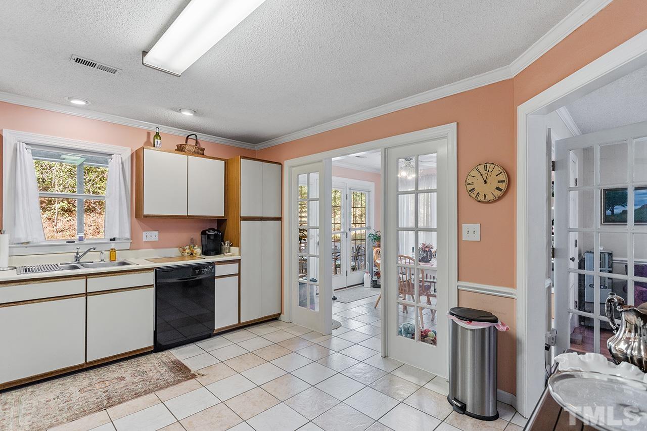 4200 Settlement Drive Durham, NC 27713 - Photo 11 of 32 a large kitchen with stainless steel appliances granite countertop a refrigerator and a sink