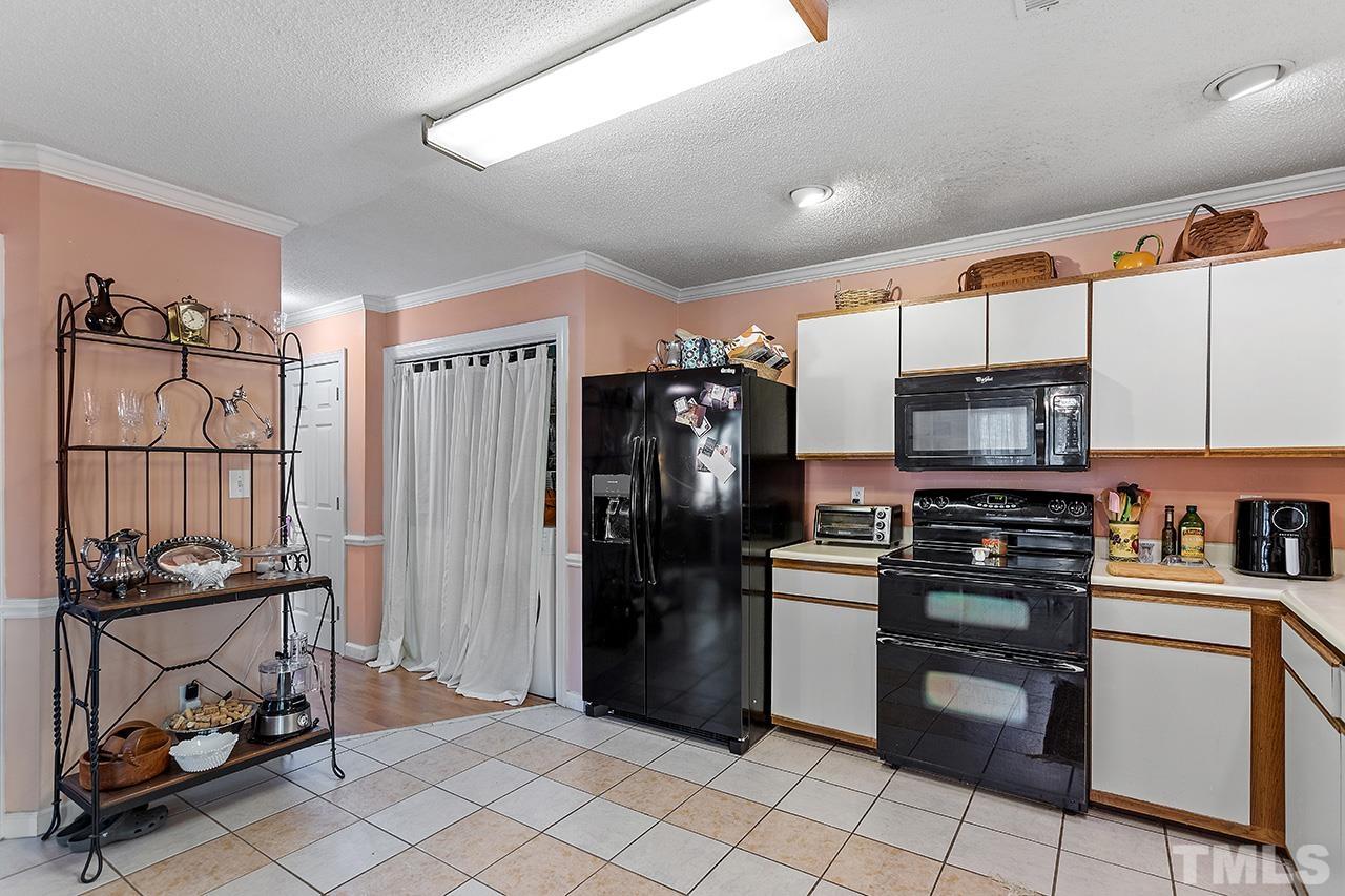 4200 Settlement Drive Durham, NC 27713 - Photo 13 of 32 a kitchen with stainless steel appliances granite countertop a refrigerator and a stove top oven
