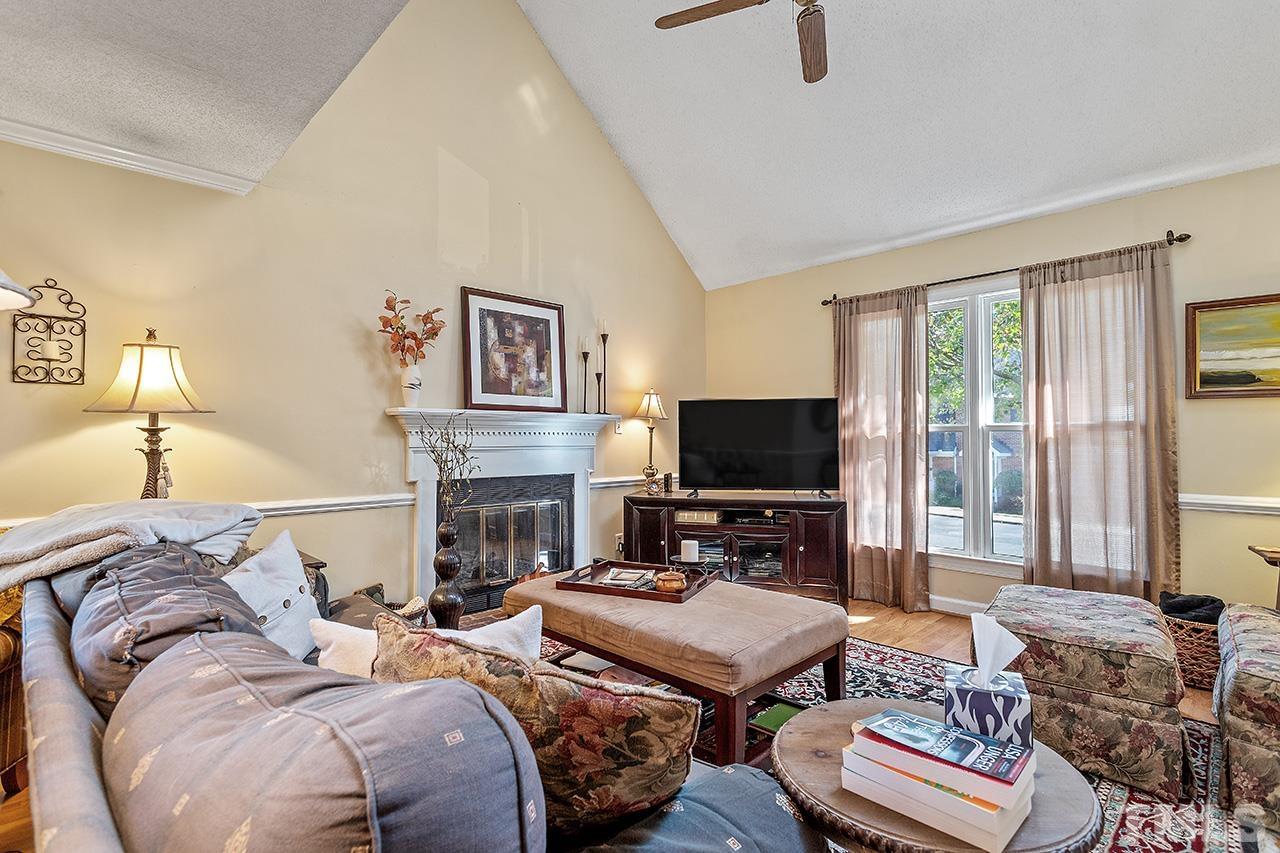 4200 Settlement Drive Durham, NC 27713 - Photo 19 of 32 a living room with furniture a fireplace and a flat screen tv