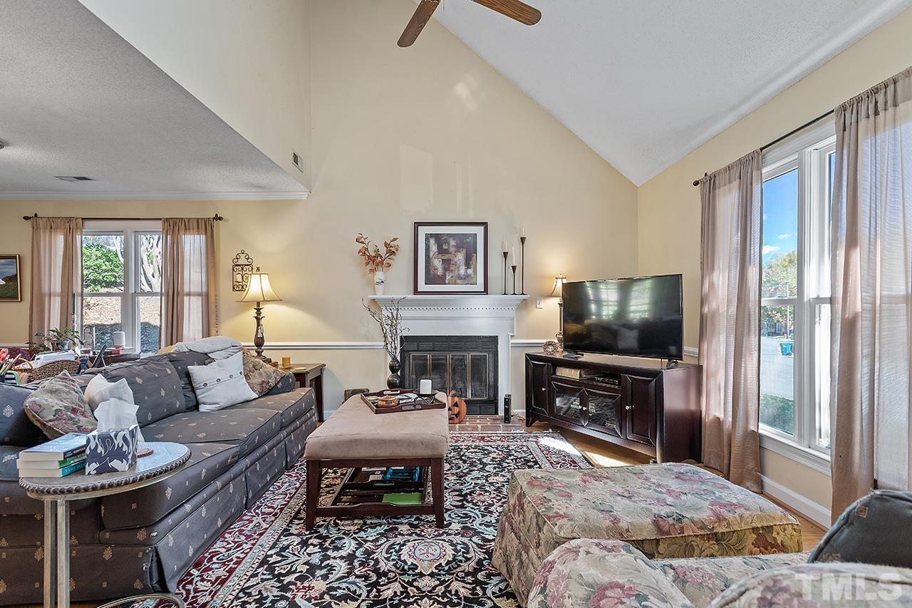 4200 Settlement Drive Durham, NC 27713 - Photo 20 of 32 a living room with furniture a flat screen tv and a large window