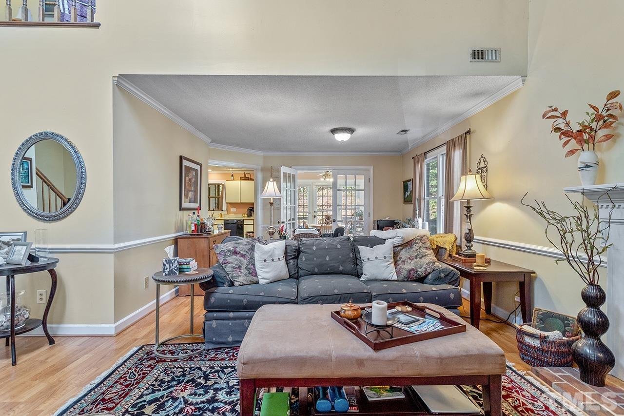 4200 Settlement Drive Durham, NC 27713 - Photo 22 of 32 a living room with furniture a rug and wall painting
