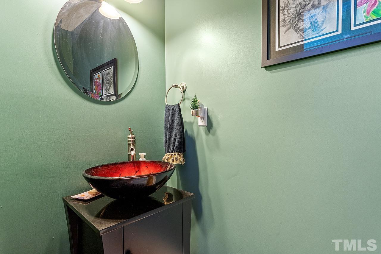 4200 Settlement Drive Durham, NC 27713 - Photo 24 of 32 a bathroom with a toilet and a mirror