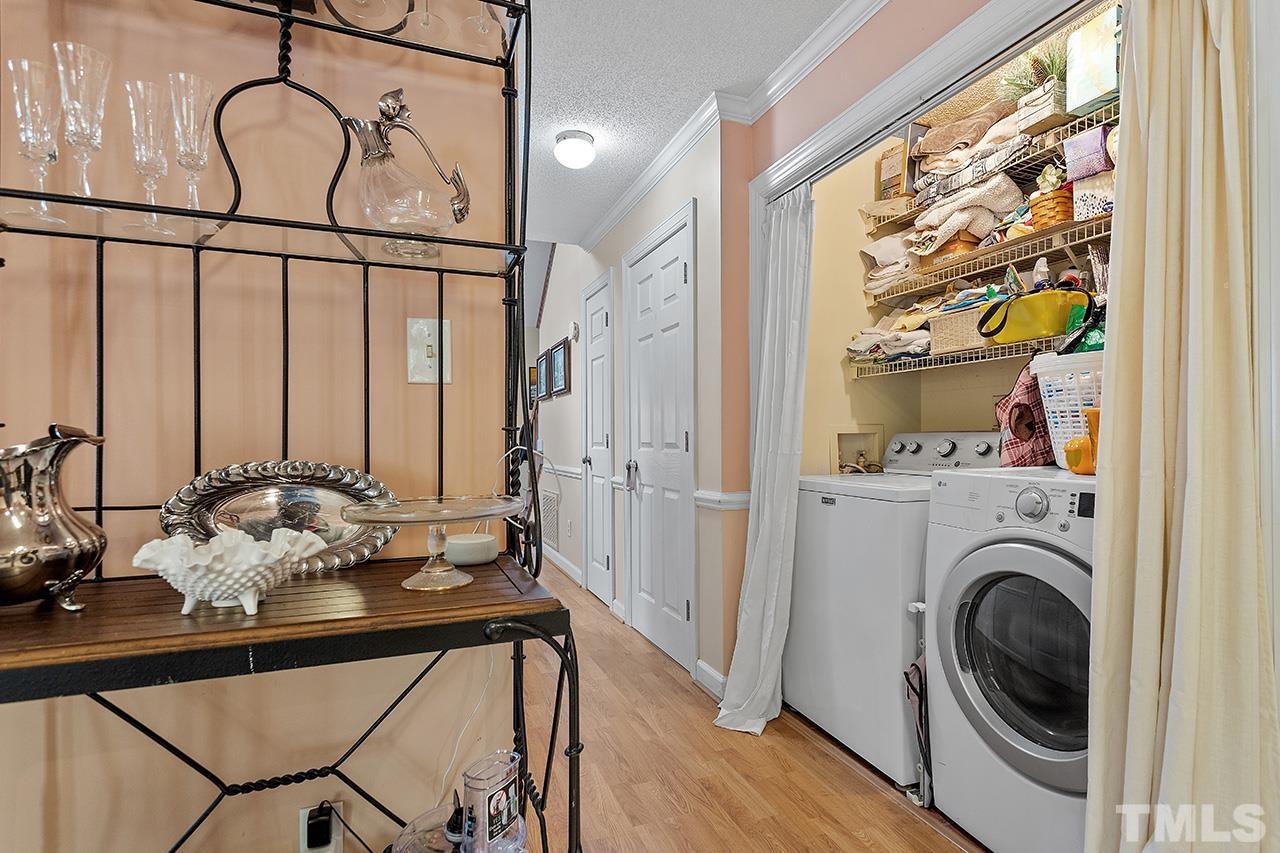 4200 Settlement Drive Durham, NC 27713 - Photo 25 of 32 a view of a hallway with washer and dryer