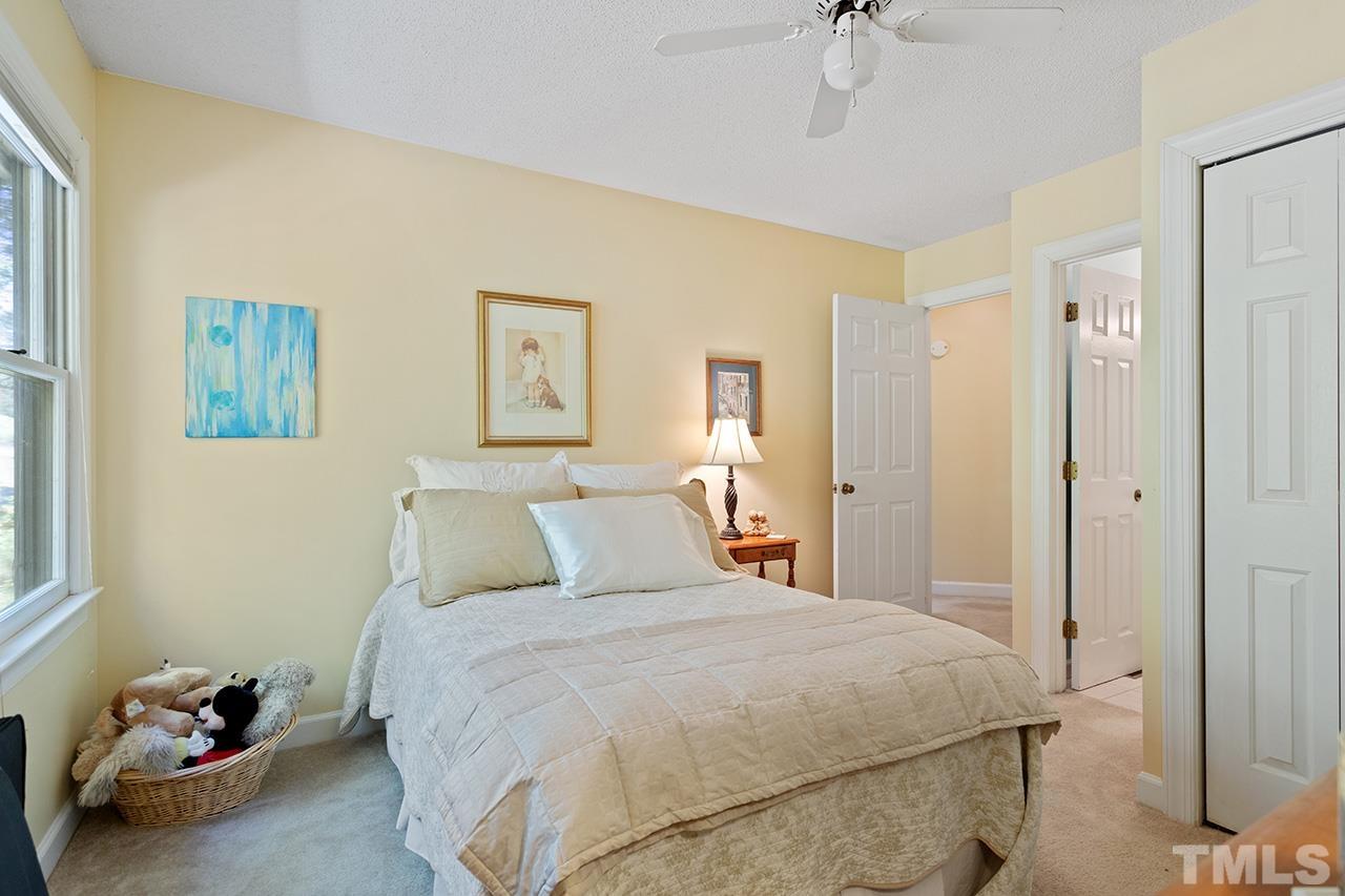 4200 Settlement Drive Durham, NC 27713 - Photo 26 of 32 a bedroom with a bed and a chandelier