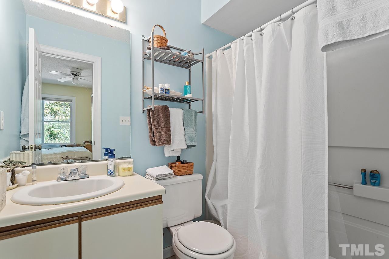 4200 Settlement Drive Durham, NC 27713 - Photo 27 of 32 a bathroom with a sink toilet and shower