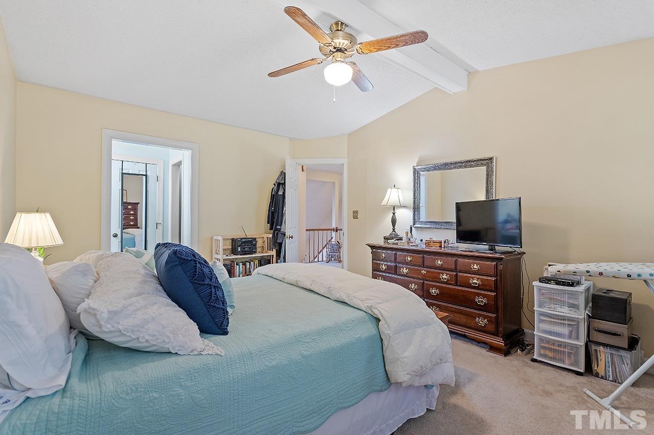 4200 Settlement Drive Durham, NC 27713 - Photo 31 of 32 a bedroom with a bed and a flat screen tv