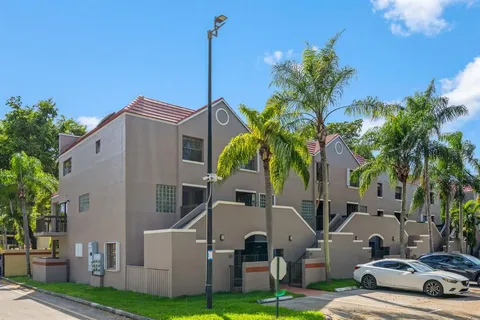 a front view of multiple houses with yard