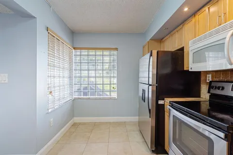 a kitchen with appliances cabinets and a sink