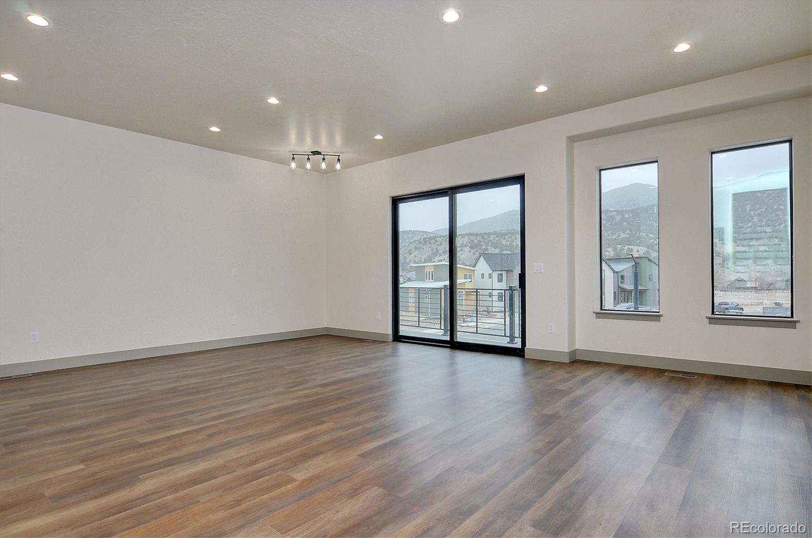 6398 Cleora Road, Unit D Salida, CO 81201 - Photo 17 of 34 a view of an empty room with wooden floor and a window