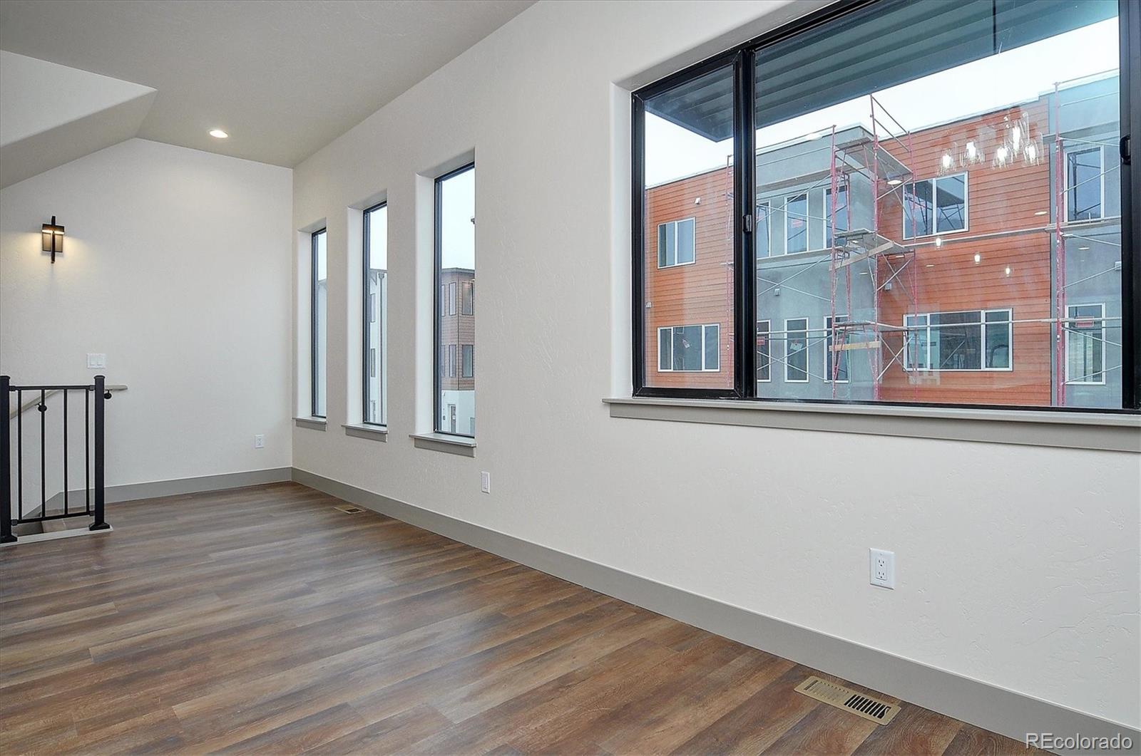 6398 Cleora Road, Unit D Salida, CO 81201 - Photo 20 of 34 a view of an empty room with wooden floor and a window