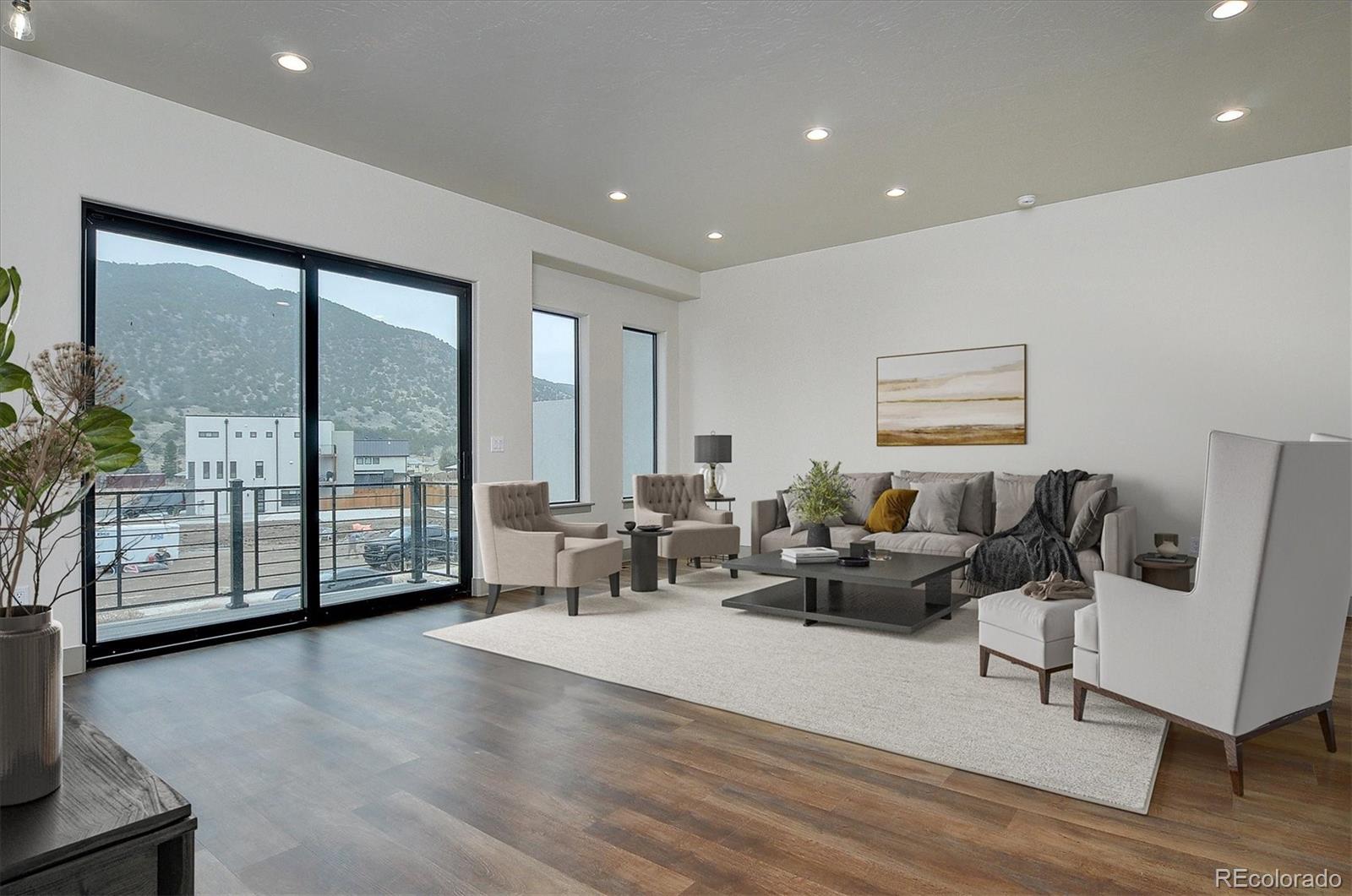 6398 Cleora Road, Unit D Salida, CO 81201 - Photo 3 of 34 a living room with furniture and large windows