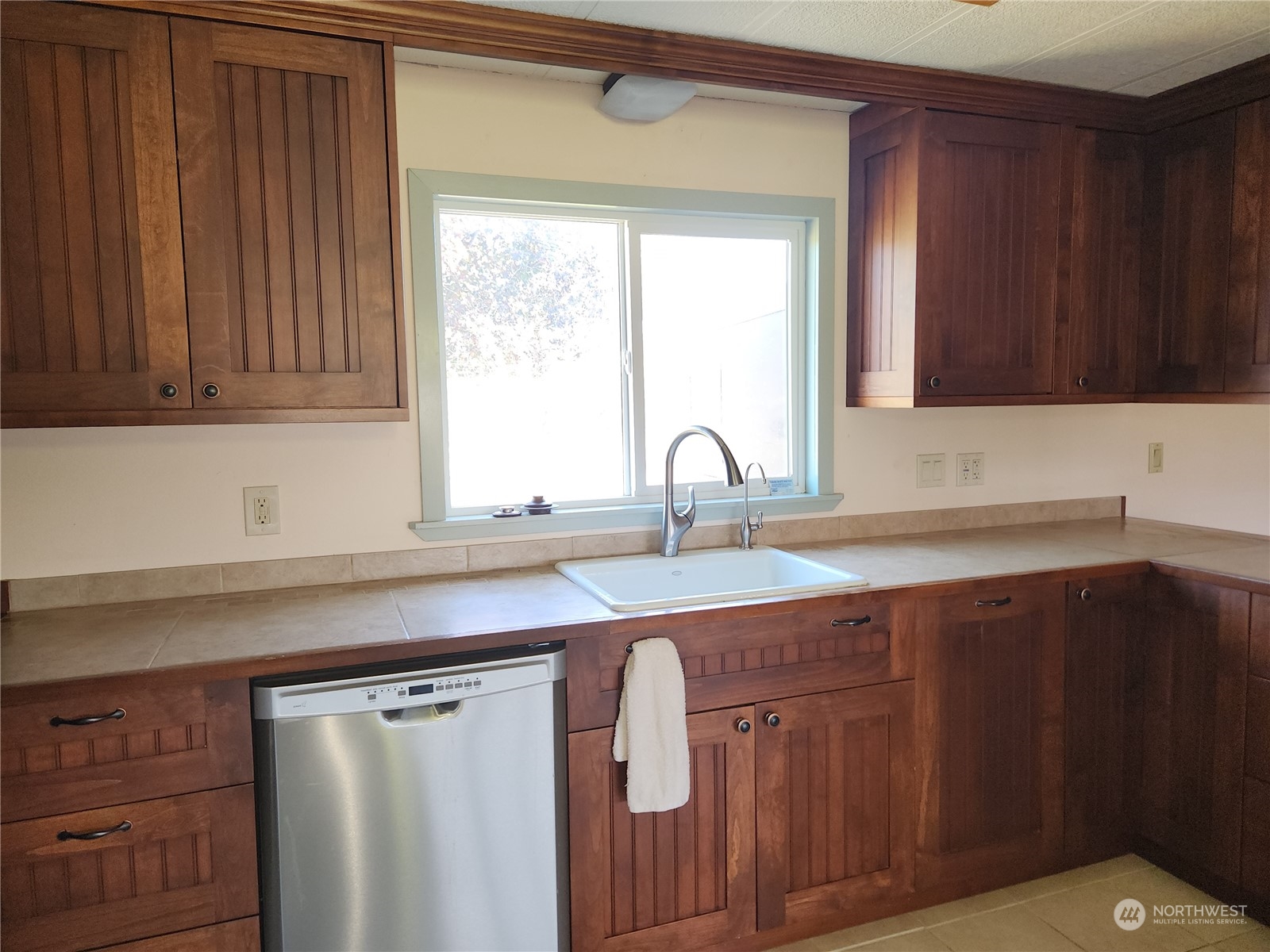 182 Engh Road Omak, WA 98841 - Photo 12 of 40 a kitchen with stainless steel appliances granite countertop wooden cabinets a sink and dishwasher