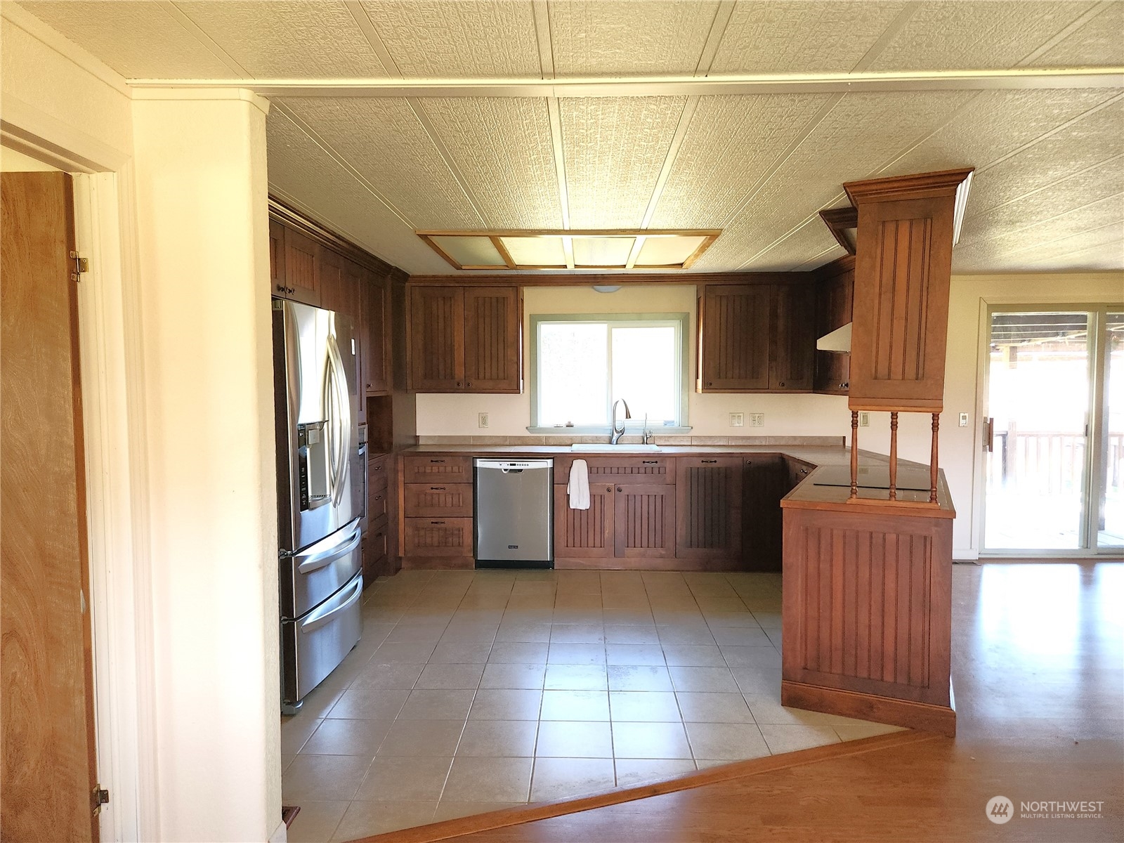 182 Engh Road Omak, WA 98841 - Photo 9 of 40 a kitchen with stainless steel appliances granite countertop a refrigerator and a stove top oven