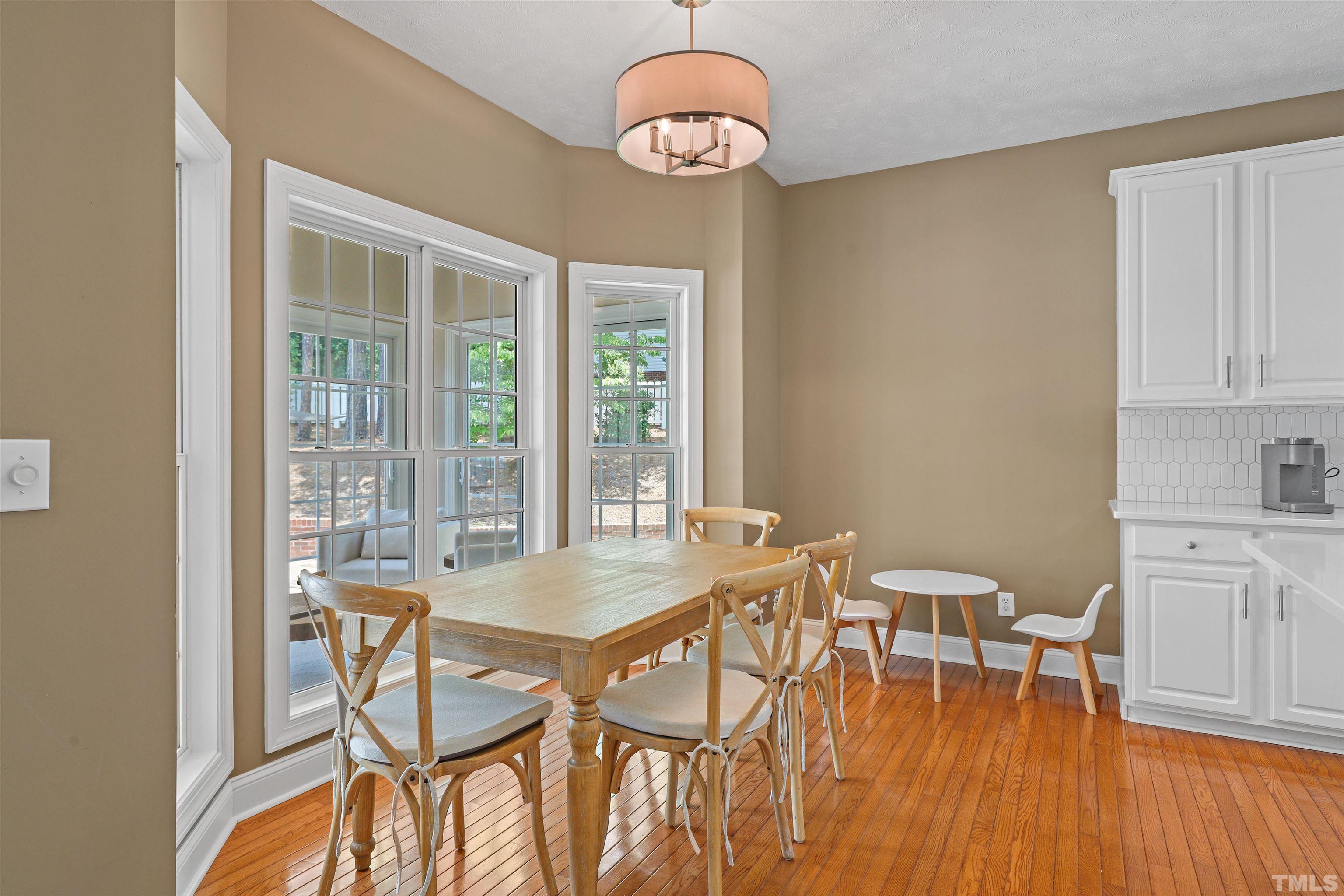 655 Elk Road Southern Pines, NC 28387 - Photo 15 of 45 a view of a dining room with furniture wooden floor and a chandelier