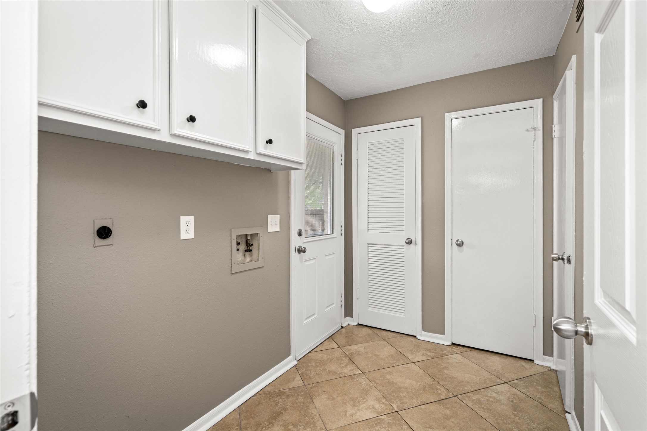 24915 Butterwick Drive Spring, TX 77389 - Photo 17 of 20 Your laundry day is simplified in this spacious utility room, complete with built-in cabinetry and extra storage space.